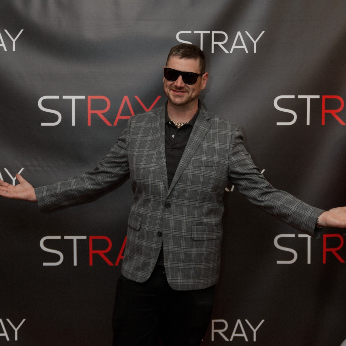 director michael p blevins posing for his picture at the stray movie announcement event